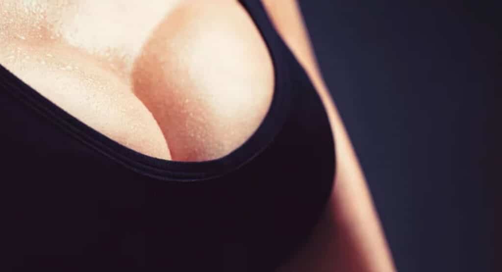 Woman, huge breasts, big boobs. Plastic surgery. Woman with big natural sexy boobs in lingerie. Closeup of sexy female breast in black bra
