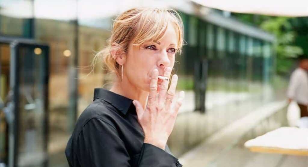 Middle aged woman smoking cigarette
