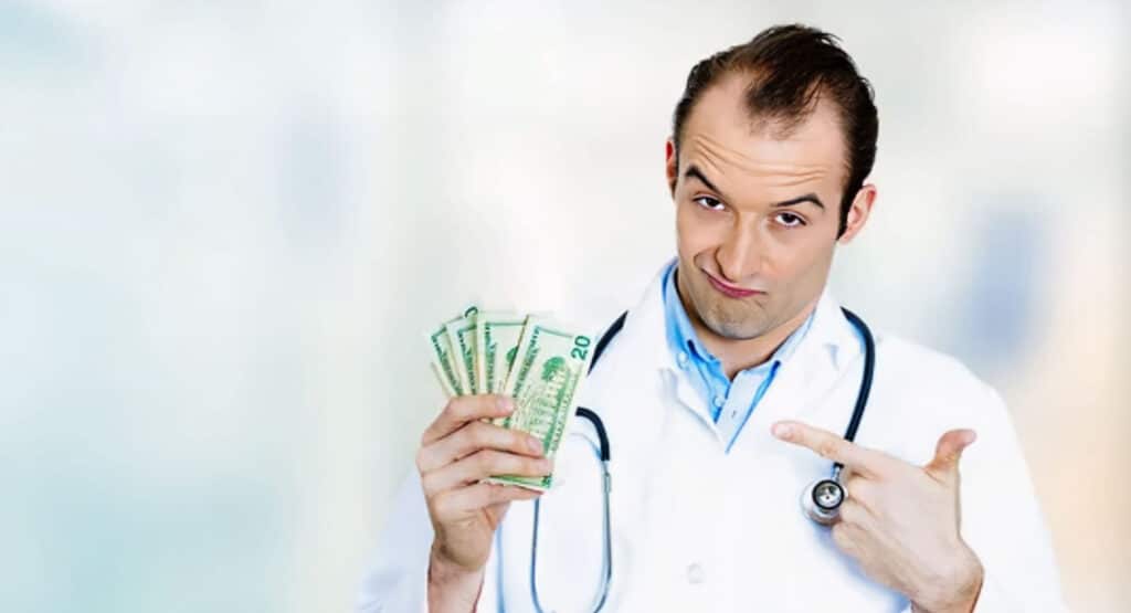 health care professional male doctor holding money dollar